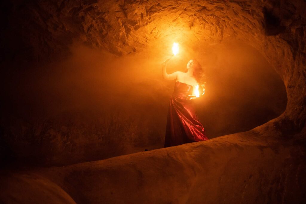 Redhead with flames in a cave